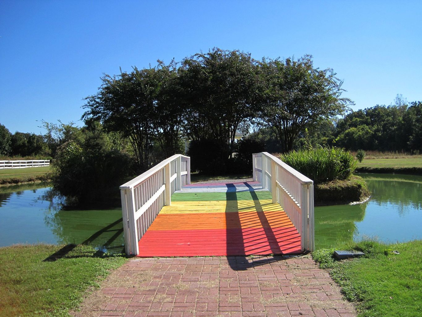 A Rainbow Bridge Across a Moat to an Island With Trees A Rainbow Bridge Across a Moat to an Island With Trees