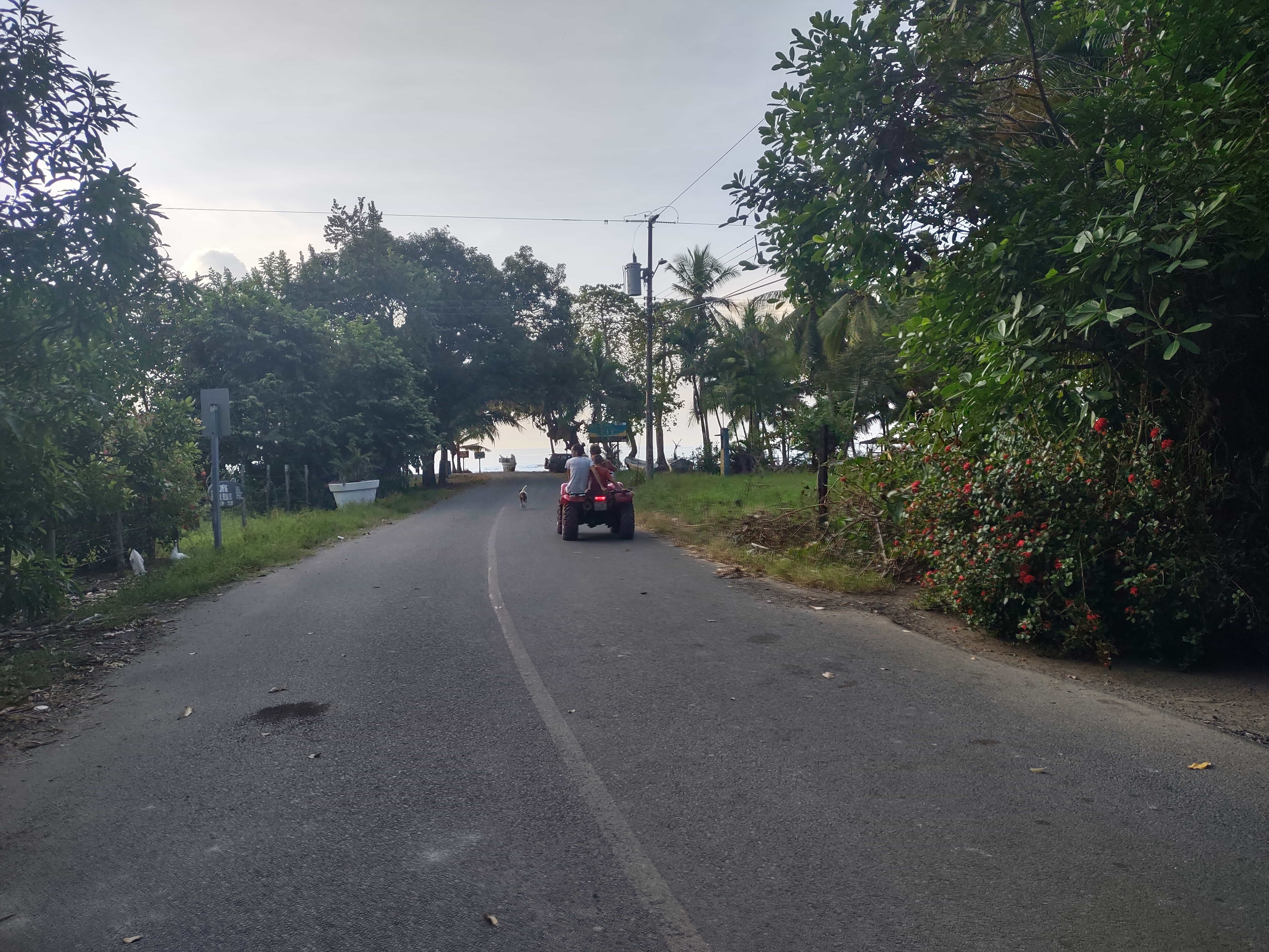 A Family Going Down the Road in an ATV in Esterillos Oeste A Family Going Down the Road in an ATV in Esterillos Oeste