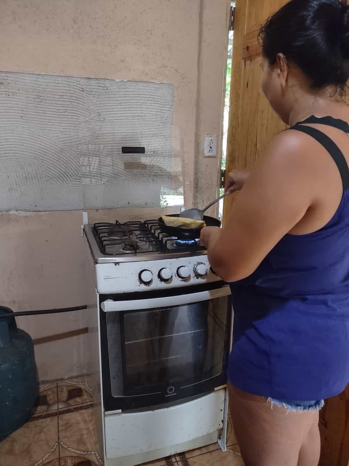 Jessica Standing at the Stove Cooking the Empanadas