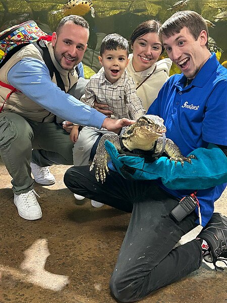 Are Tegus Good Pets? This Tegu Is Being Held by a Young Man With a Big Smile on His Face. There Are Also Two Adults and a Child Nearby