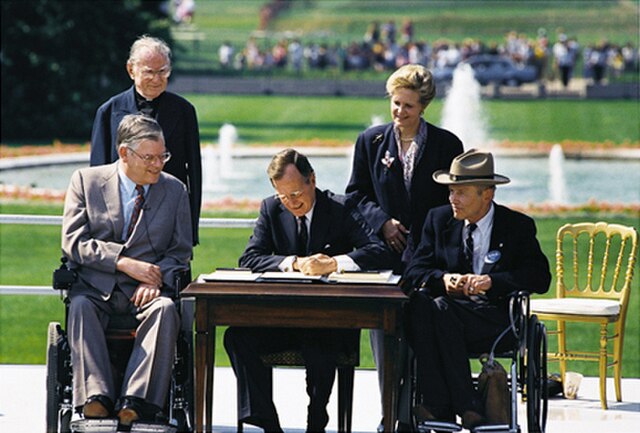 President HW Bush signing the ADA - public domain