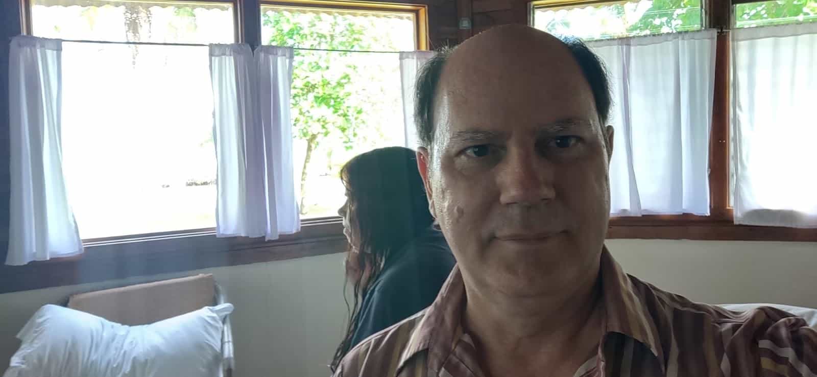 A Selfie of my Husband with Me in the Background. We are Inside of our Room at Corcovado Beach Lodge A Selfie of my Husband with Me in the Background. We are Inside of our Room at Corcovado Beach Lodge