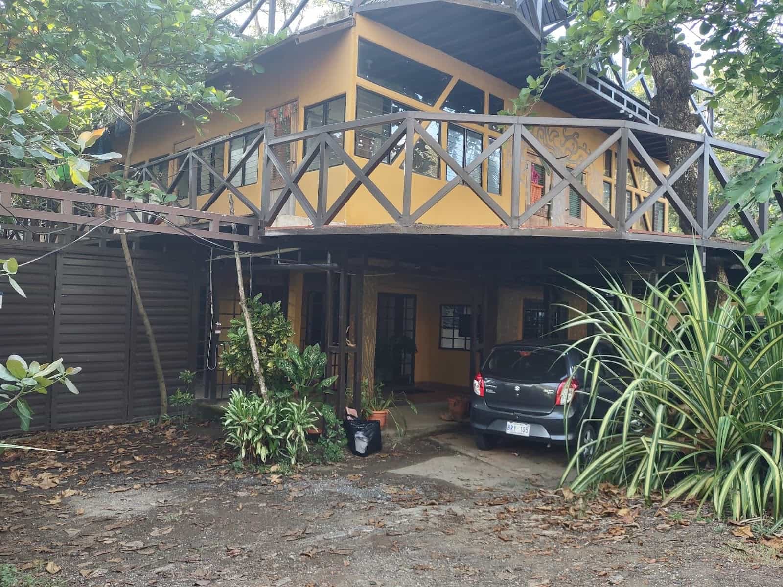 Larger Two Story House With a Car Parked Underneath a Car Port in Esterillos Oeste