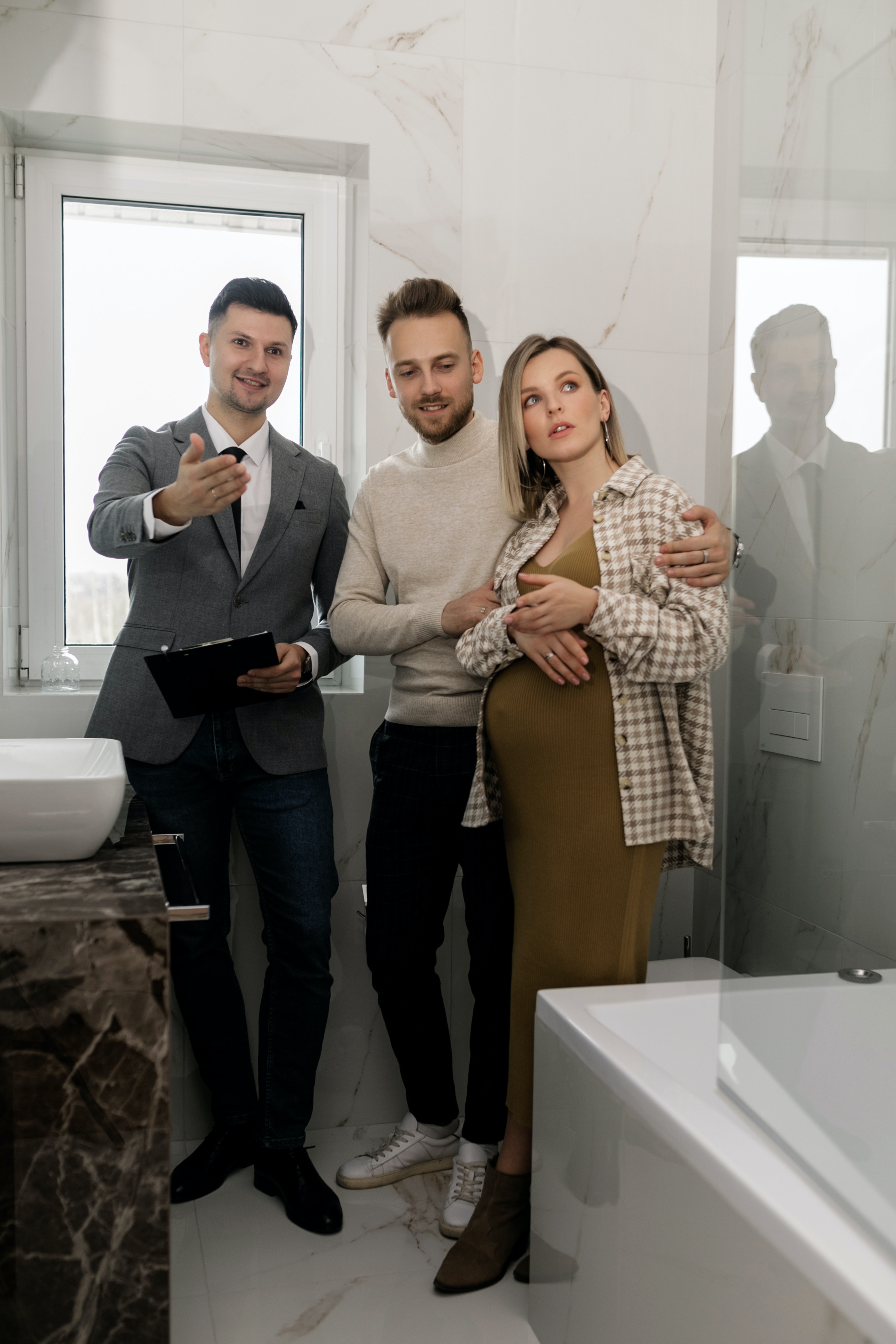 Inspecting a Potential Adopter's Home Before Rehoming a Pet. A man is Gesturing Around a Home and a Couple Looks On