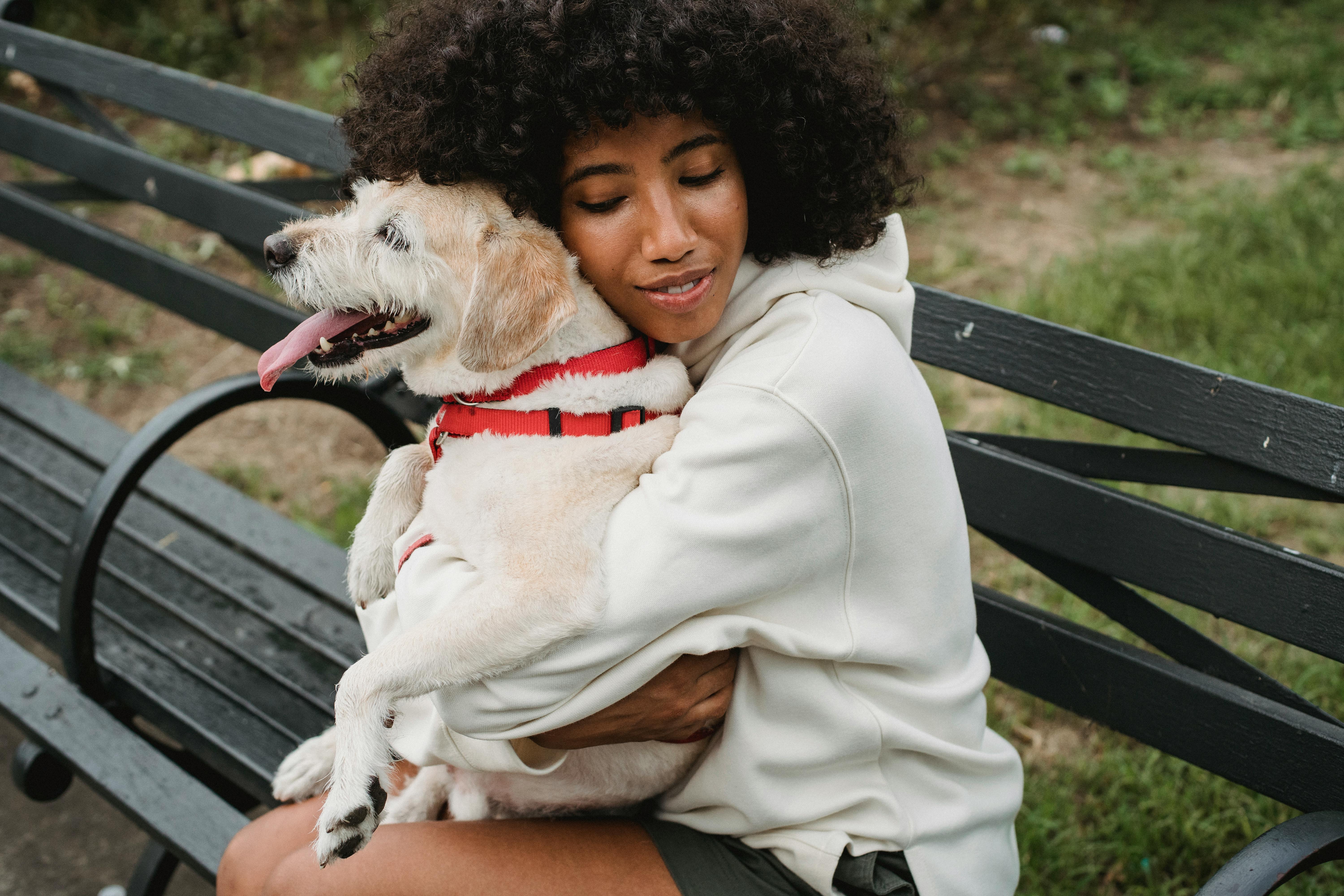Woman on a Park Bench Hugging Her Dog
