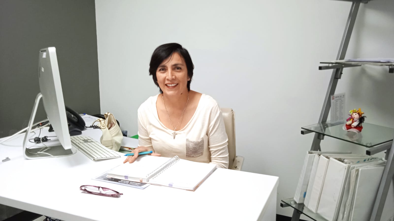 Receptionist Behind a Desk Looking at the Camera